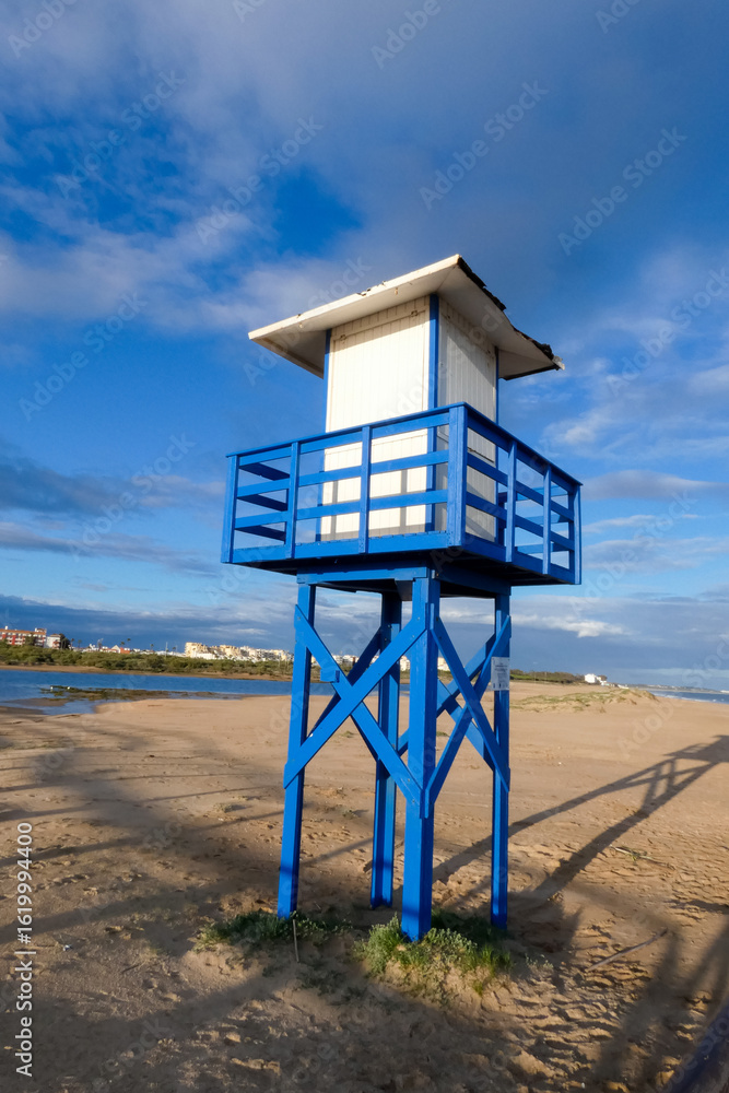 Lifeguard tower overlooking sunny beach on cloudy day Lifeguard tower overlooking sunny beach on cloudy day