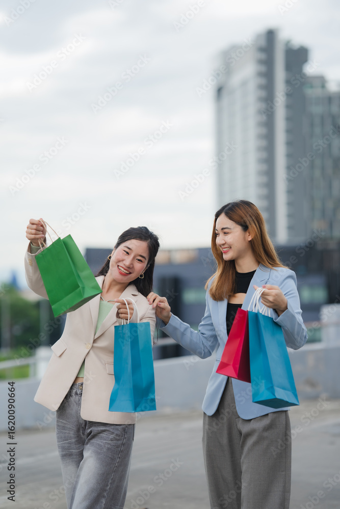 Shopping Spree: Two stylish individuals, beaming with delight, brandish their colorful shopping bags against the backdrop of a modern building, reflecting the thrill of a day of retail therapy. Shopping Spree: Two stylish individuals, beaming with delight, brandish their colorful shopping bags against the backdrop of a modern building, reflecting the thrill of a day of retail therapy.
