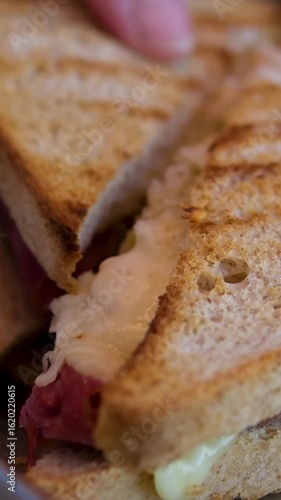 Wallpaper Mural Eating a Delicious Bacon, Cheese and Egg Sandwich. High quality 4k footage Torontodigital.ca