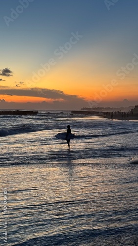 Surfer at Sunset in Bali, Indonesia