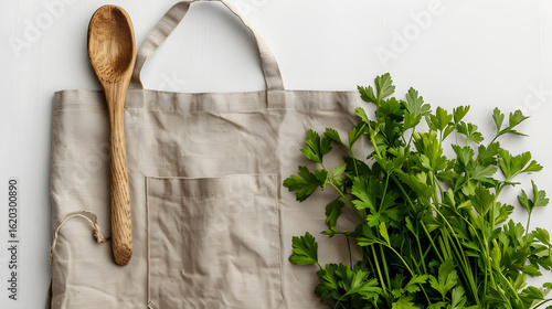 Beige Linen Apron Mockup with Wooden Spoon and Parsley on White Background, in high resolution clean minimal style stock photo illustration background image ideal for templates advertisements and weba