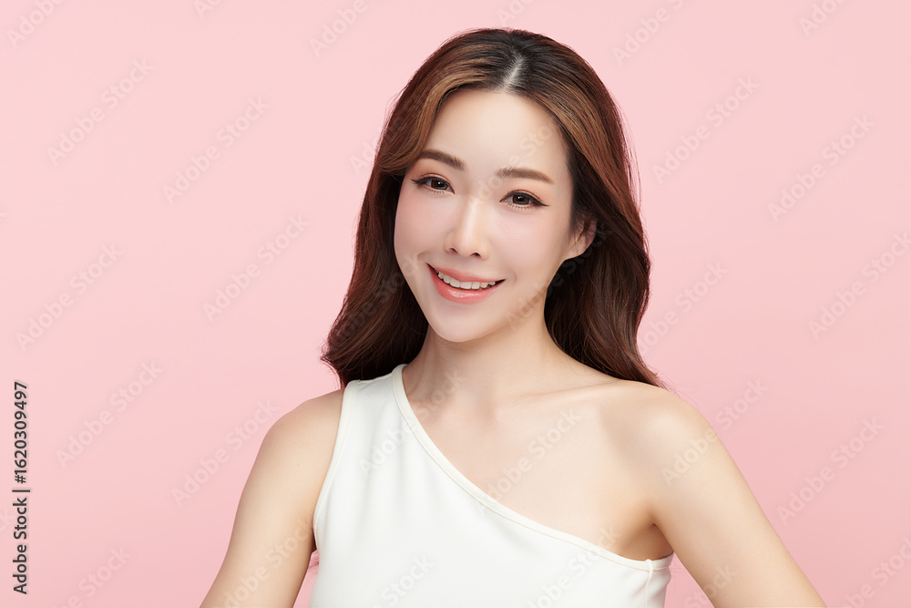 A beautiful young Asian woman with clean, fresh skin against a pink background. Skincare, facial treatment, cosmetology, beauty, and spa. An elegant portrait of an Asian woman. A beautiful young Asian woman with clean, fresh skin against a pink background. Skincare, facial treatment, cosmetology, beauty, and spa. An elegant portrait of an Asian woman.