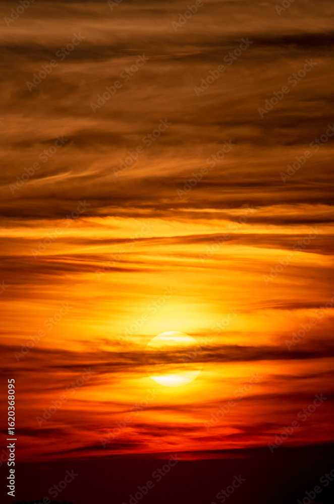 Fototapeta premium Epic sunset cloudscape sky with vibrant orange and red hues