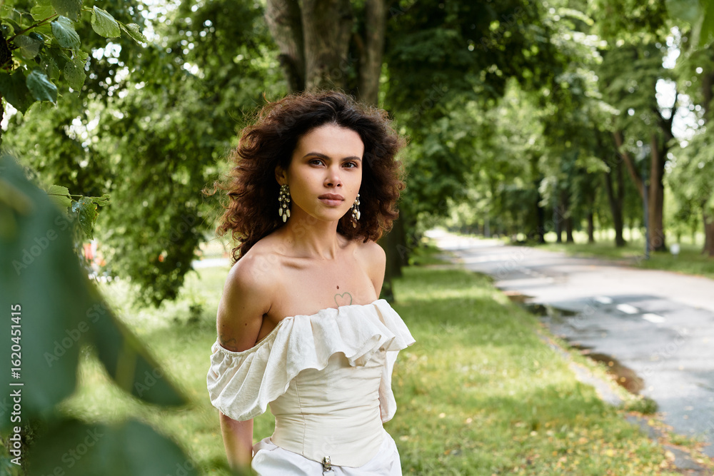Curly haired woman in summer dress embraces nature in a serene village park setting Curly haired woman in summer dress embraces nature in a serene village park setting