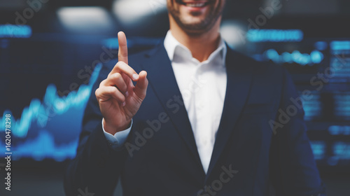 Faceless businessman in a suit is smiling and holding up his index finger.
