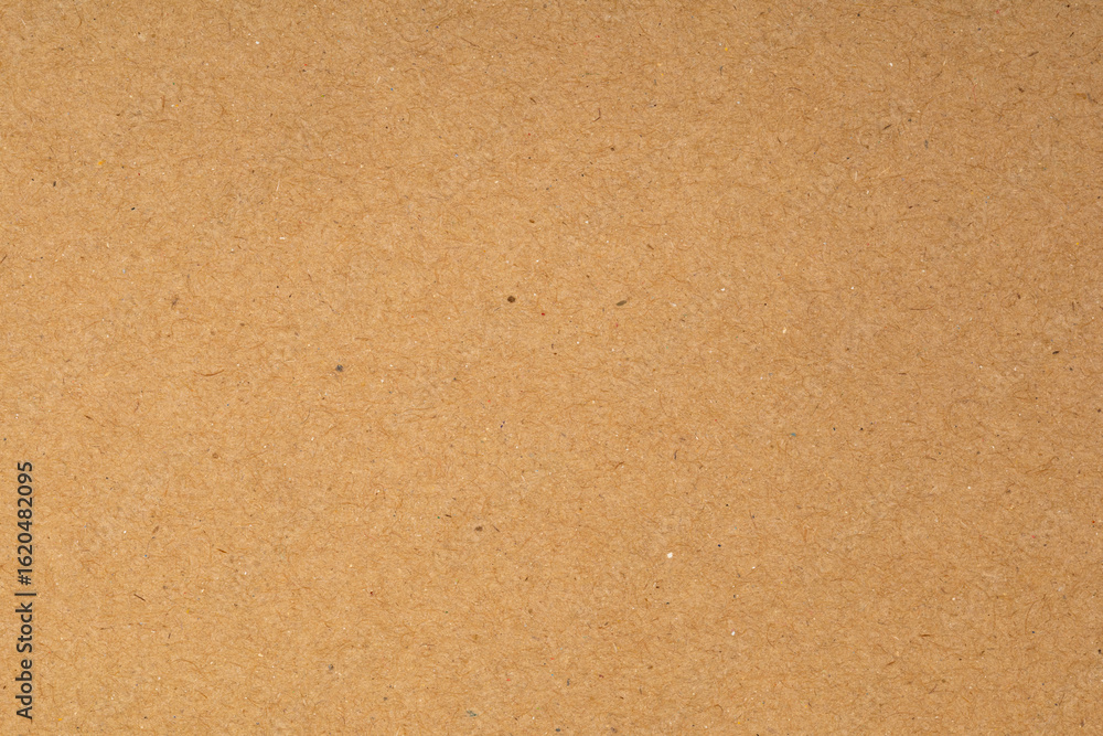 Fototapeta premium Brown cardboard or fiberboard texture background. Kraft paper sheet pattern for design, packaging, and eco-friendly concepts.