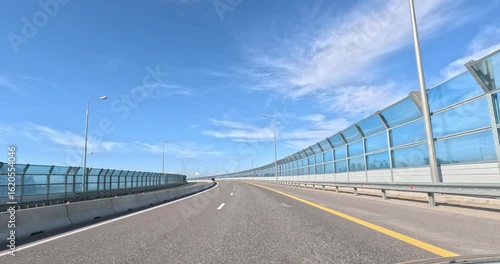 View from the windshield of a car while driving on a road.