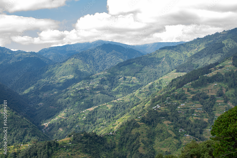 Fototapeta premium Sun rays falling on Himalayan mountain range, scenic beauty of layers of mountains, Okhrey, sikkim, India. Okhrey village a remote place in Sikkim where mountain range view is enjoyed by tourists.