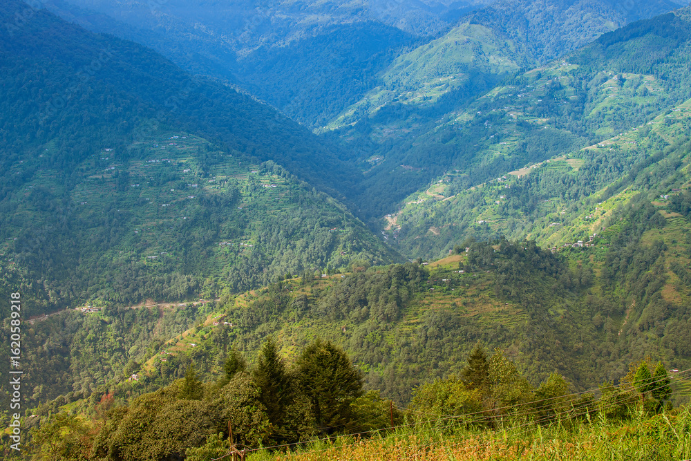 Naklejka premium Beautiful Sun rays falling on Himalayan mountain range, play of light, scenic beauty of Okhrey, sikkim, India. Okhrey village a remote place in Sikkim where mountain range view is enjoyed by tourists.