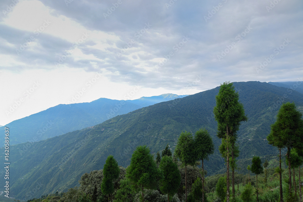 Naklejka premium Scenic beauty of layers of mountains, Okhrey, sikkim, India. Okhrey village of one of the remotest places in Sikkim where peaceful, tranquil Himalayan mountain range is enjoyed by tourists from India.