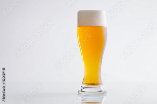 a glass of beer sitting on a table