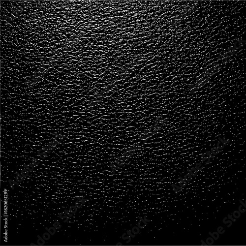 Close up view of a dark textured surface with small irregular shapes and light reflecting points evenly spread