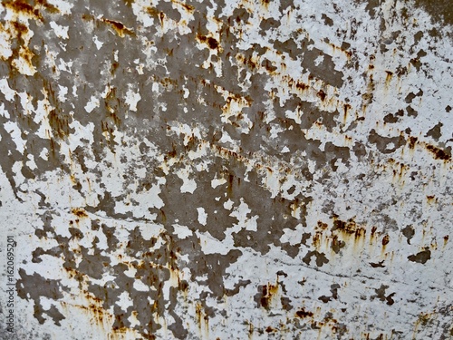Texture of weathered metal showing peeling white paint and rust stains. Ideal for use in design, industrial-themed backgrounds, games, film design, or concept art