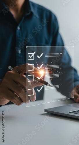 Hand pointing at digital checklist with laptop. Organization and productivity concept. Professional workspace with task management.