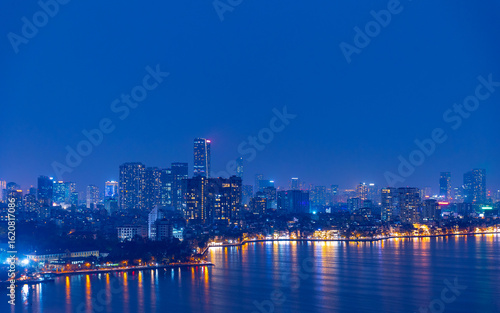 Wallpaper Mural Hanoi skyline at night with illuminated buildings and reflective water Torontodigital.ca