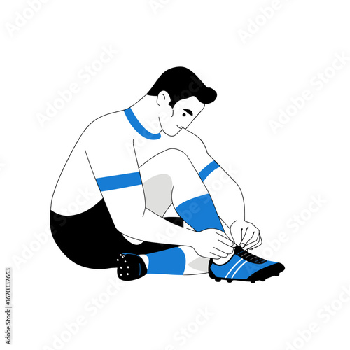 A footballer preparing before the match, lacing his boot.