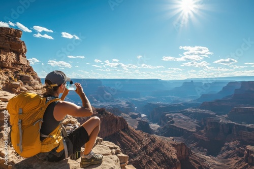 A hiker enjoys a scenic vista of a grand canyon.
