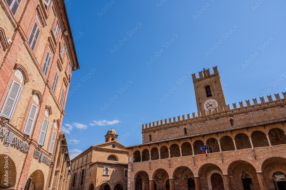 Fototapeta premium Offida. Town Hall. Built between the 13th and 14th centuries (central crenellated tower). The façade is preceded by a 7-arched portico with an elegant 14-arched loggia raised in the 15th century.