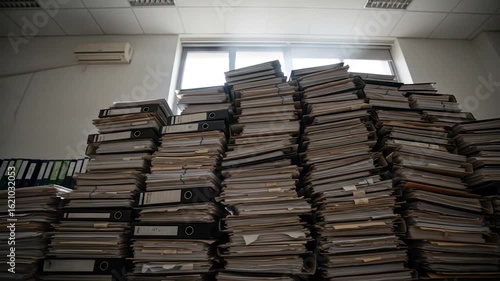 Overwhelmed by Paperwork: A Mountain of Files in Office