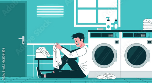 Sad man with shrunk shirt sitting in laundry room feeling hopeless and frustrated with washing machine accident