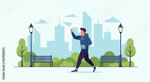 Man enjoying leisure time throwing paper airplane in the park with city view background