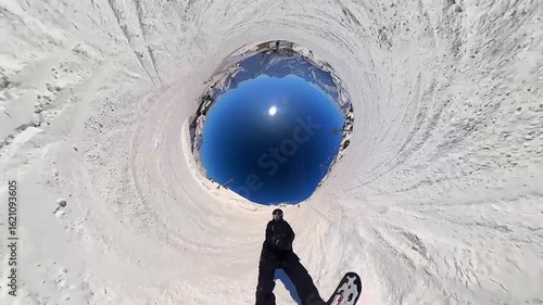 Wallpaper Mural Snowboarding. A snowboarder rides down a mountain slope at a ski resort. Extreme sports and a healthy lifestyle. Pleasure and drive. Winter snow, sun and blue sky 24 Torontodigital.ca