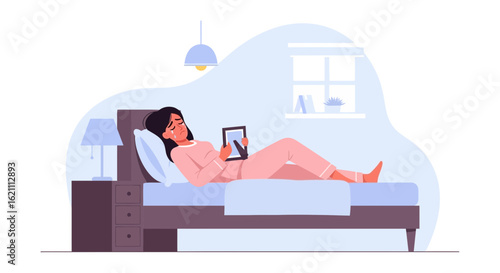 Heartbroken Woman Lying On Bed Looking At Framed Photo In Bedroom