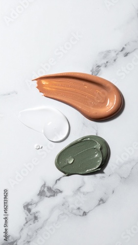 Top View of Cosmetic Cream Swatches on Elegant Marble Counter Background