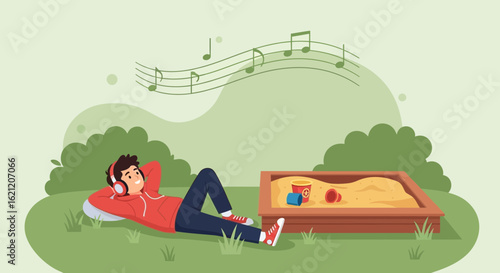 Boy Enjoying Music Outdoors Relaxing In The Park Beside A Sandbox