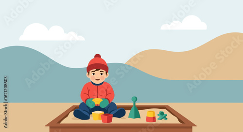 Boy In Winter Clothing Enjoys Sandbox Play On A Sunny Day Outdoor Landscape