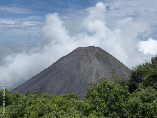 Izalco Volcano rising above clouds in El Salvador