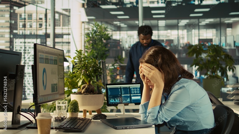 Accountant in busy modern startup agency imputing financial figures on PC after checking reports. Focused businesswoman working in modern office, crosschecking data, camera B Accountant in busy modern startup agency imputing financial figures on PC after checking reports. Focused businesswoman working in modern office, crosschecking data, camera B