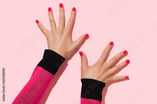 Womans hands with pink nail design. Manicure, pedicure beauty salon concept. Deep long shadows