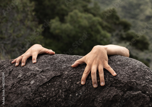 Slika na platnu lone climber hand gripping rock edge symbolizes hopelessness, danger, risk