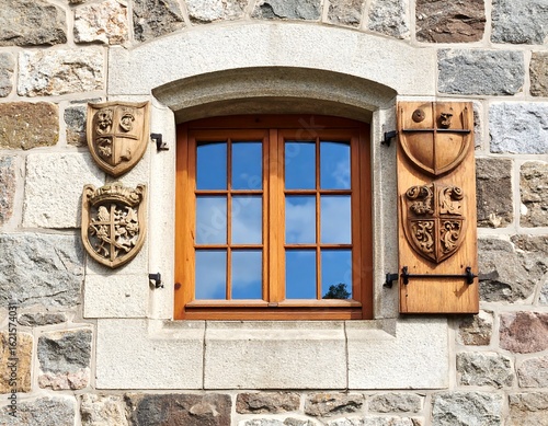 Old stone wall with wooden window