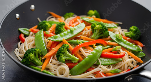 Delicious stir-fry with noodles, vegetables, and sesame seeds. A healthy and vibrant meal.