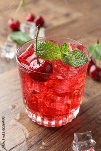 Wallpaper Mural Tasty cherry soda with ice cubes, berries and mint in glass on wooden table, closeup Torontodigital.ca
