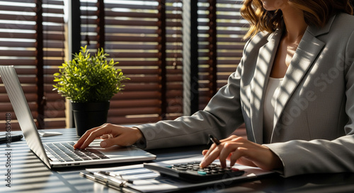 Focused Businesswoman Calculating in Modern Office.