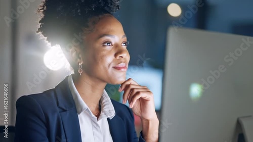 Portrait Of a Smiling Businesswoman in a Navy Blue Suit Working at Computer in Modern Office at Night