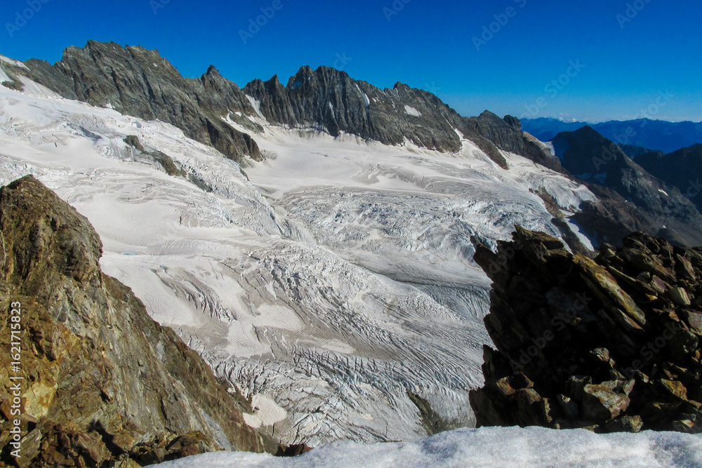 Obraz premium Alps mountains snow ridges view of Monte Rosa massive. Lyskamm, Pollux and Castor summits above the clouds stunning landscape mountains view. Alps high attitude extreme terrain climbing and glacier