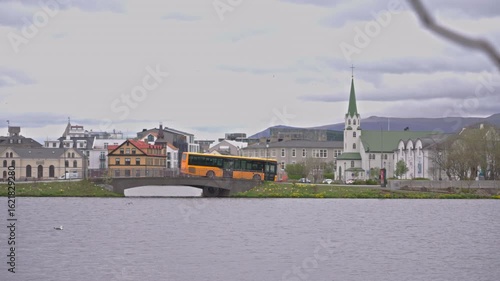 Transit bus crosses bridge in downtown Reykjavik under overcast clouds