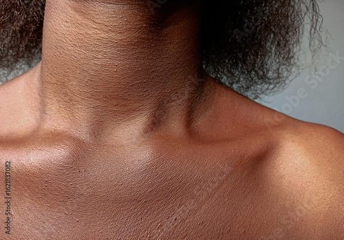 Front view of African woman neck and collarbone. Close up of hollow or deep neckline of brown skin female.
