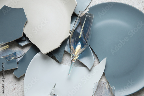 Фотография Broken plates and glasses on grunge background, closeup