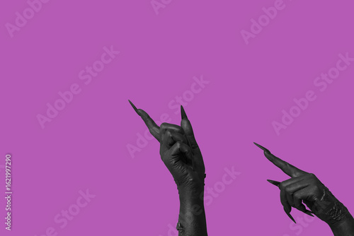 Black hands of witch pointi...