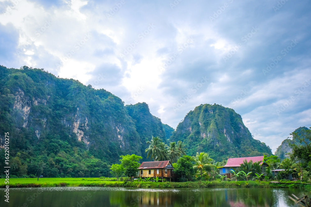 Fototapeta premium Beautiful limestones and water reflections in Rammang Rammang park near Makassar, South Sulawesi, Indonesia