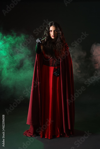 Young witch with magic wand...