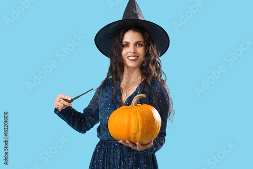 Young witch with wand and H...