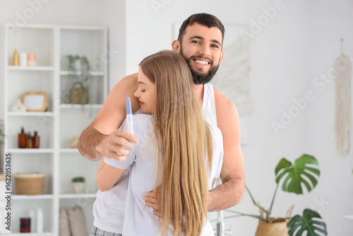 Happy young couple with pre...