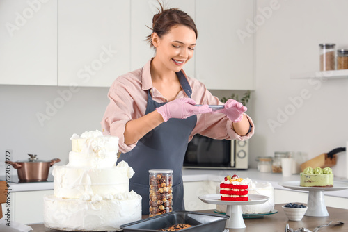 Female confectioner taking ...