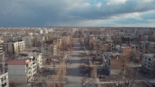Aerial view of a completely destroyed urban landscape with endless rows of bombed-out buildings and lifeless streets, capturing the haunting silence, total desolation left by prolonged armed conflict.